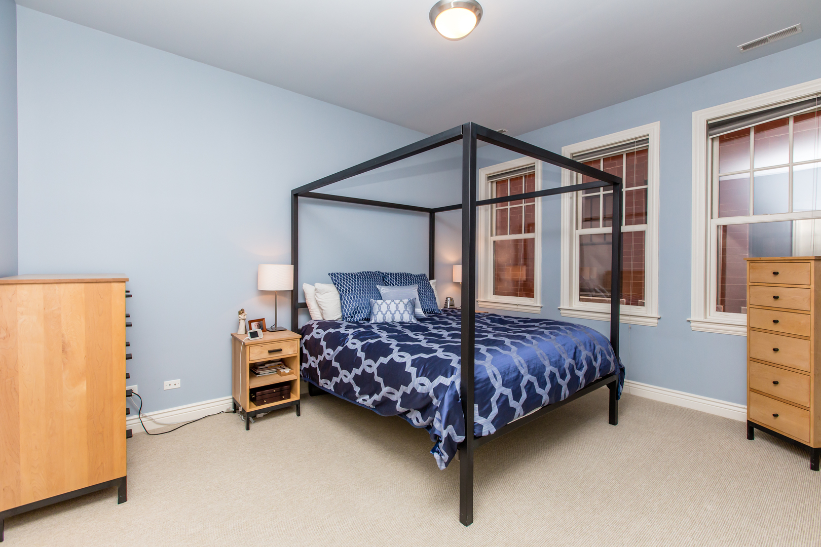 35 South Racine Avenue, Unit 4SE Chicago, IL 60607 - Photo 9 of 24 a bed sitting in a bedroom next to a window and dresser