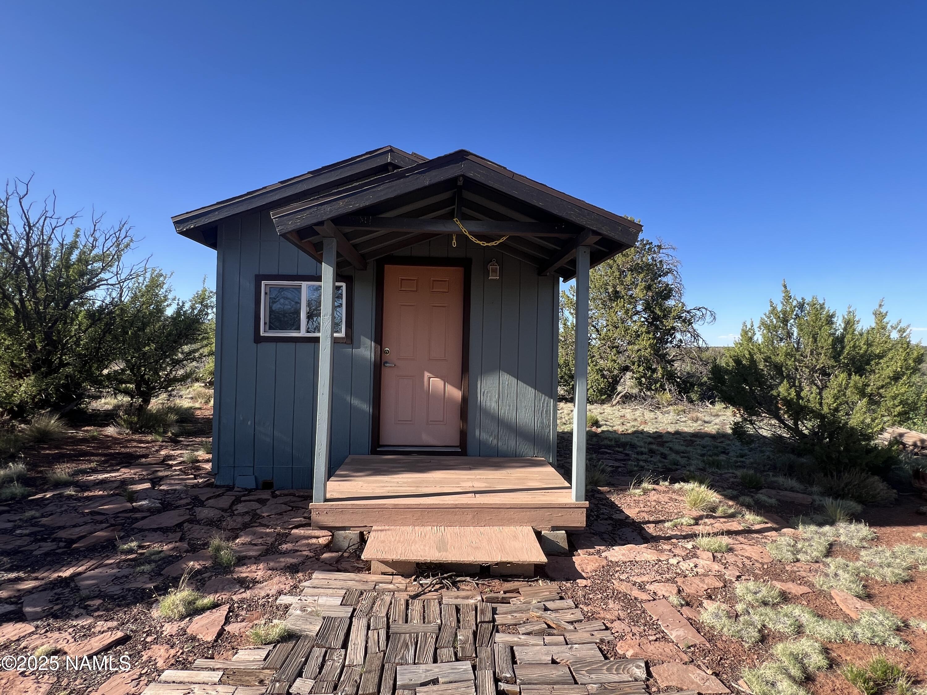 8801 South Rim Ranch Road Williams, AZ 86046 - Photo 2 of 10 a view of a house with a yard