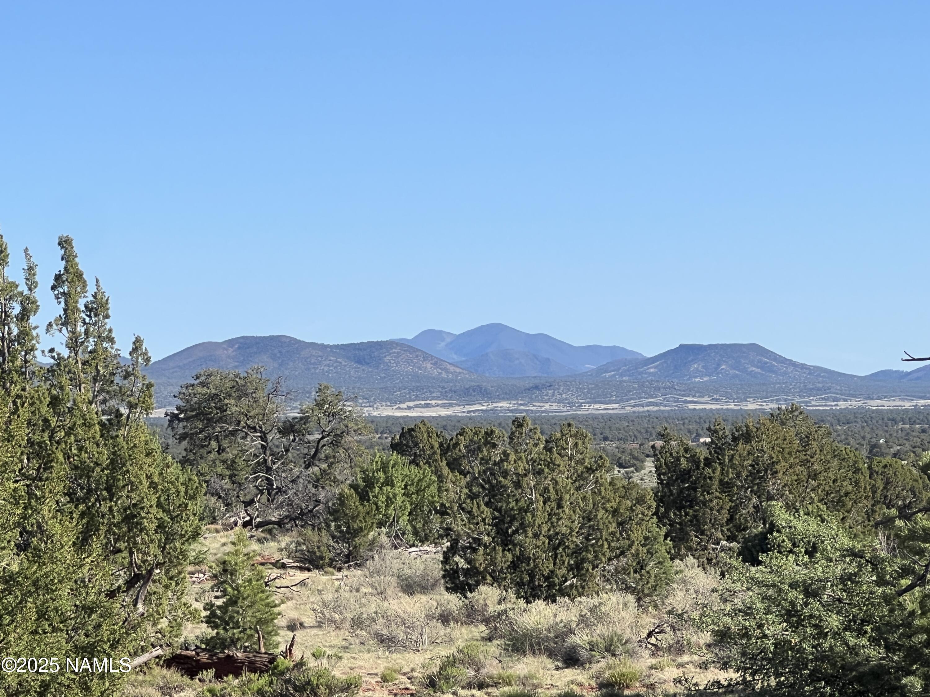 8801 South Rim Ranch Road Williams, AZ 86046 - Photo 4 of 10 a view of an mountain with a outdoor space