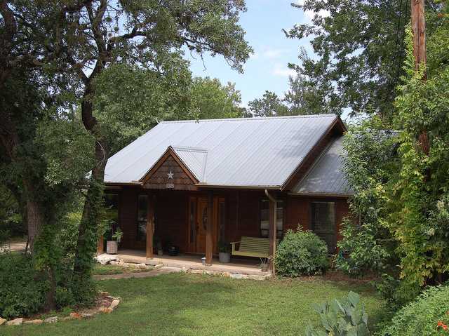 2305 Balboa Road Austin, TX 78733 - Photo 1 of 1 a front view of a house with a garden and plants