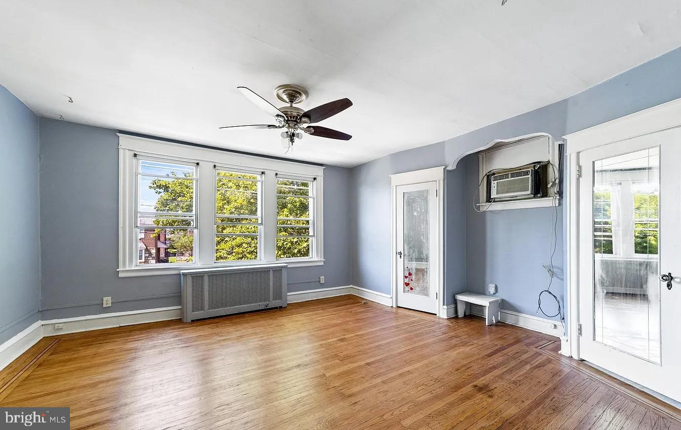 2329 Rhawn Street Philadelphia, PA 19152 - Photo 16 of 23 a view of an empty room with a window and wooden floor