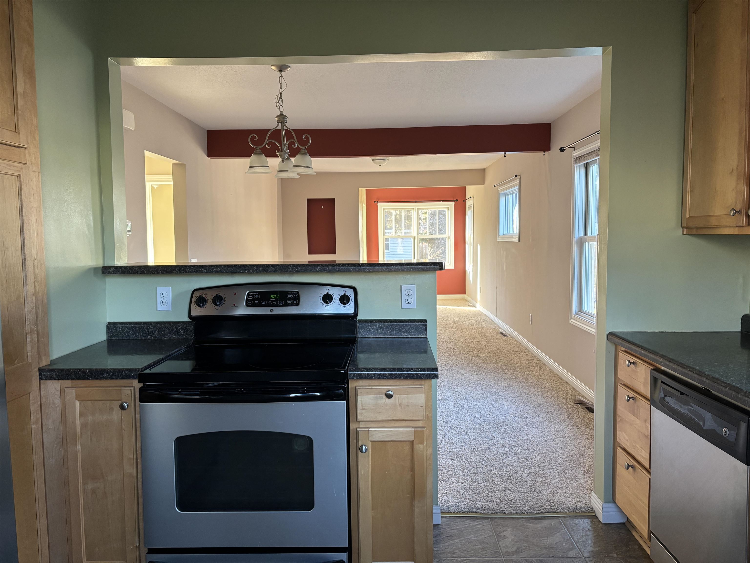21 Oak Street Proctor, MN 55810 - Photo 12 of 26 Kitchen with stainless steel appliances, dark carpet, pendant lighting, a chandelier, and light brown cabinetry