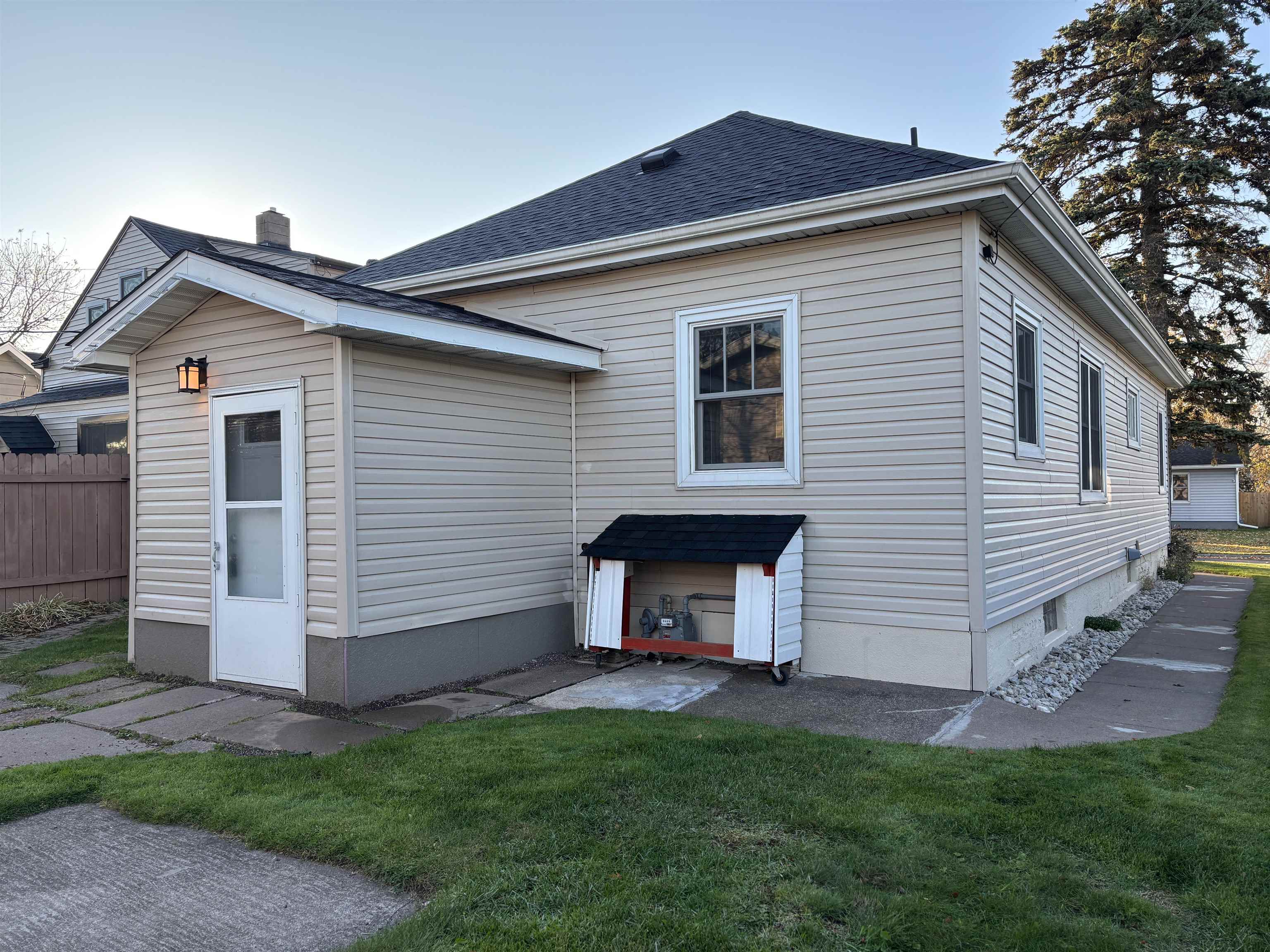 Rear view of property with a shingled roof and a chimney