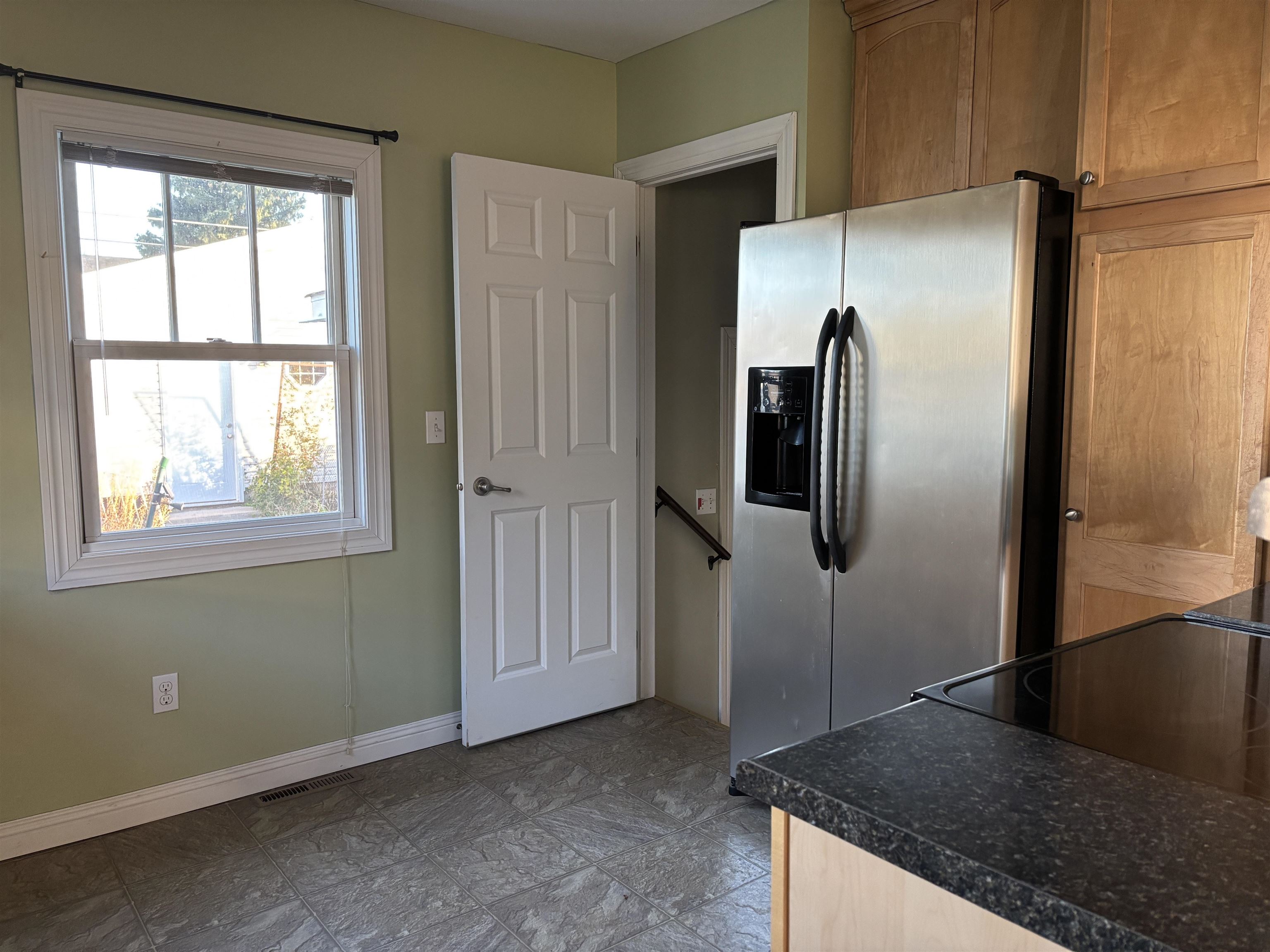 21 Oak Street Proctor, MN 55810 - Photo 10 of 26 Kitchen with stainless steel fridge with ice dispenser and dark countertops