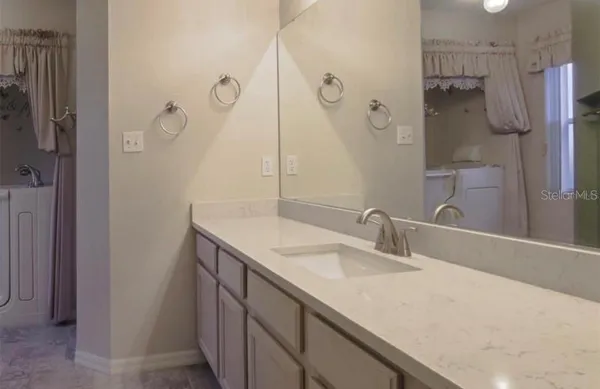 a living room with furniture rug and window
