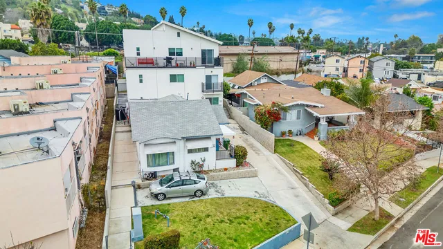 a aerial view of a house with swimming pool and furniture