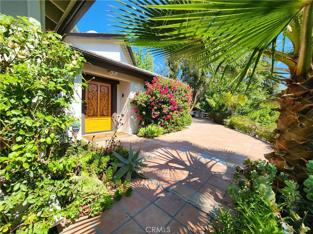 a view of a house with a flower garden