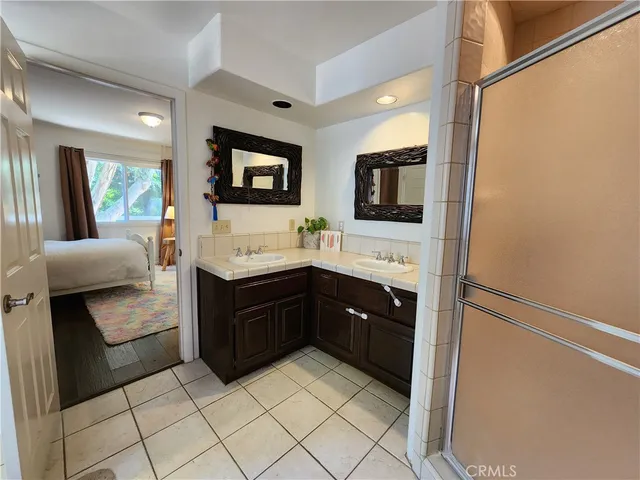 a spacious bathroom with a bathtub sink and mirror