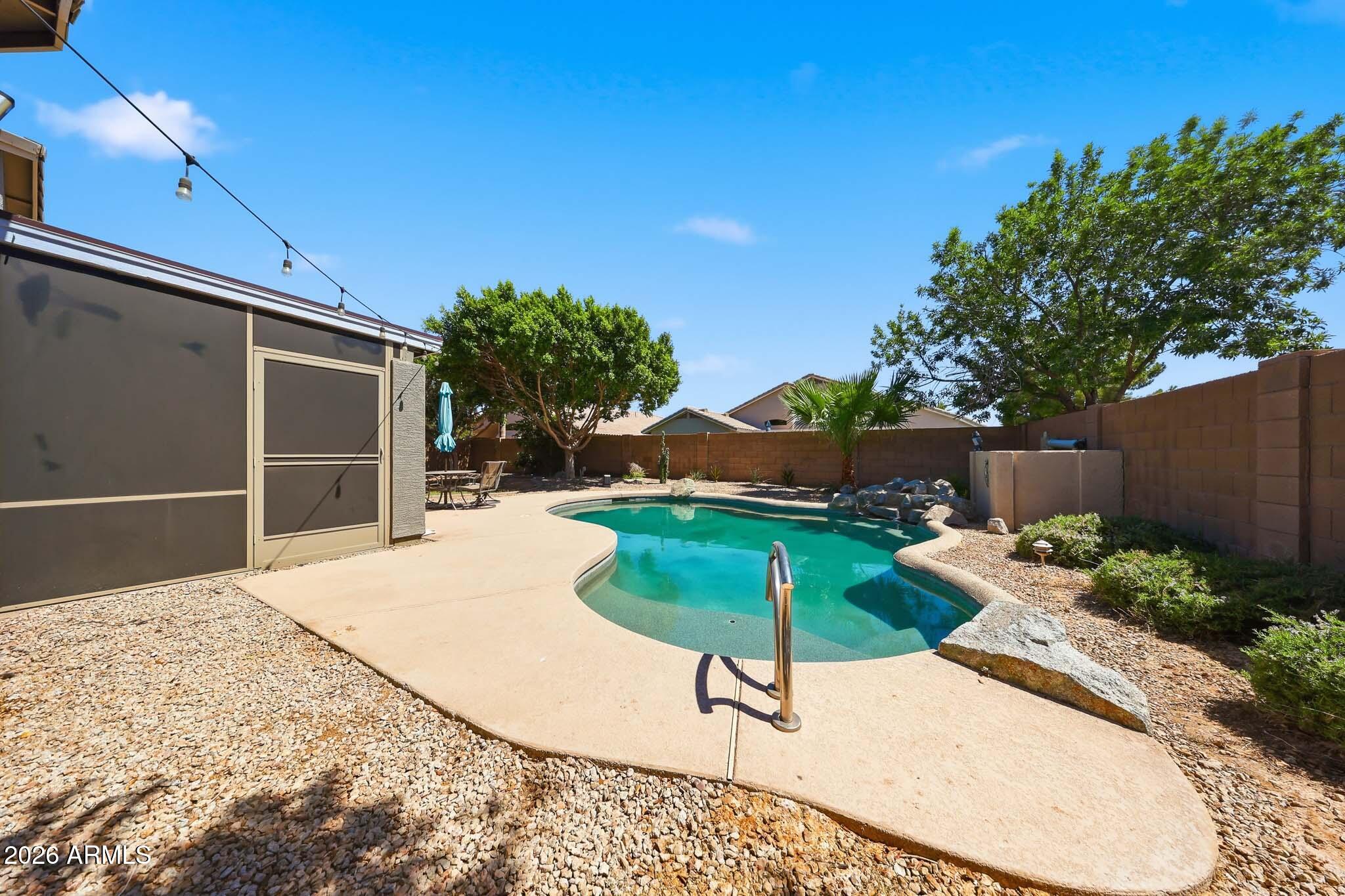 2153 East Kempton Road Chandler, AZ 85225 - Photo 46 of 50 a house with a yard and a wooden fence