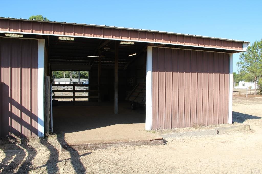 6124 Riverchase Road Milton, FL 32583 - Photo 11 of 49 36'x20' run in area w/ water mister for horses