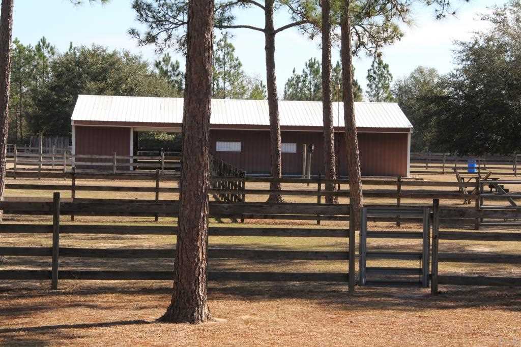 6124 Riverchase Road Milton, FL 32583 - Photo 7 of 49 Feed Room, Tack Room, 4 Stalls, Hay Storage Room