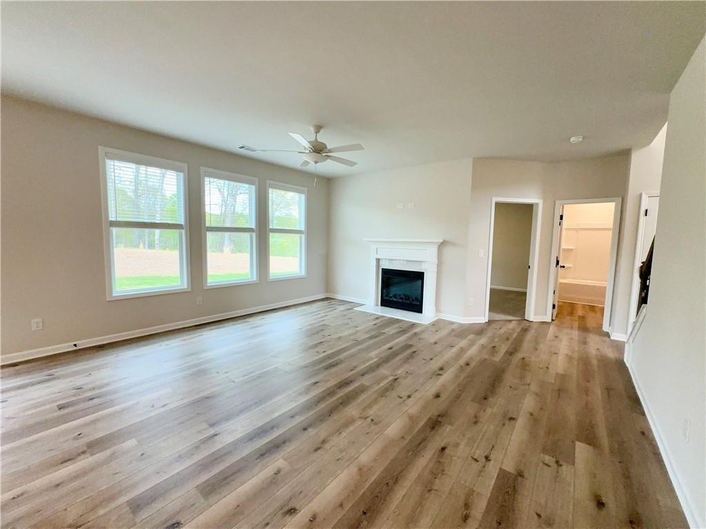 345 Rodeo Drive Auburn, GA 30011 - Photo 7 of 22 a view of an empty room with wooden floor and a window