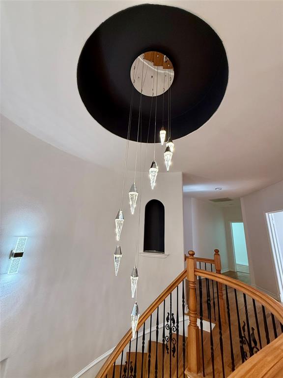 4810 Victor Street Dallas, TX 75246 - Photo 11 of 26 a view of a hallway with a chandelier fan