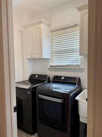 a kitchen with stainless steel appliances granite countertop white cabinets and a stove