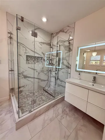a bathroom with a shower and a sink