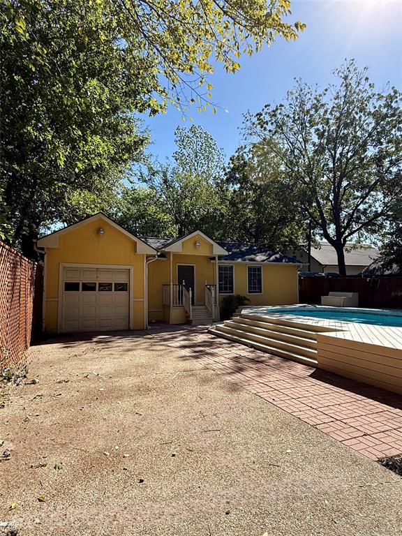 4810 Victor Street Dallas, TX 75246 - Photo 23 of 26 a house with trees in the background