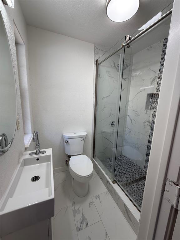 4810 Victor Street Dallas, TX 75246 - Photo 26 of 26 a bathroom with a sink toilet and shower