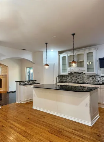 a large kitchen with stainless steel appliances granite countertop a sink and stove top oven