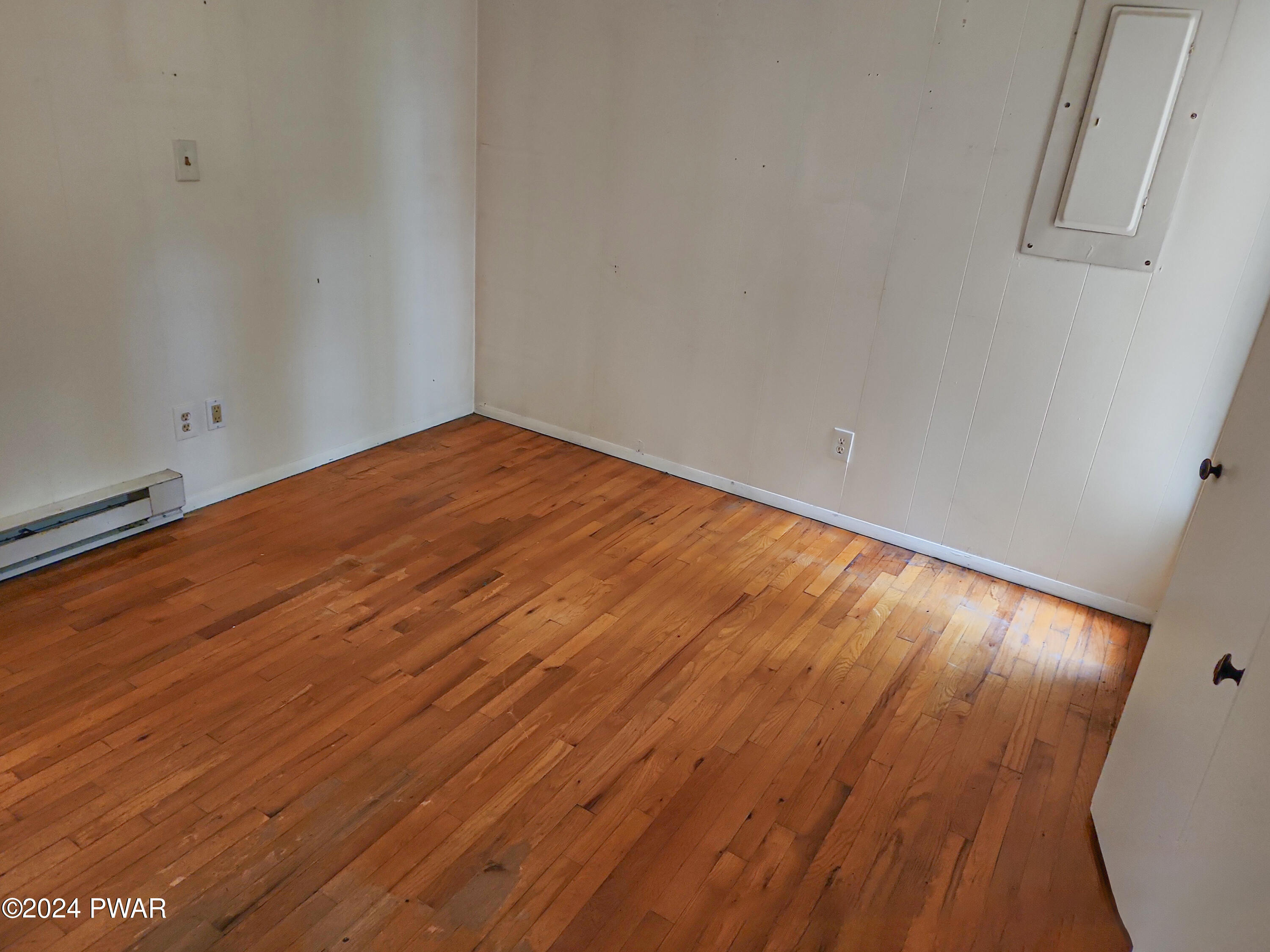 107 Rodeo Lane Hawley, PA 18428 - Photo 22 of 29 a view of empty room with wooden floor