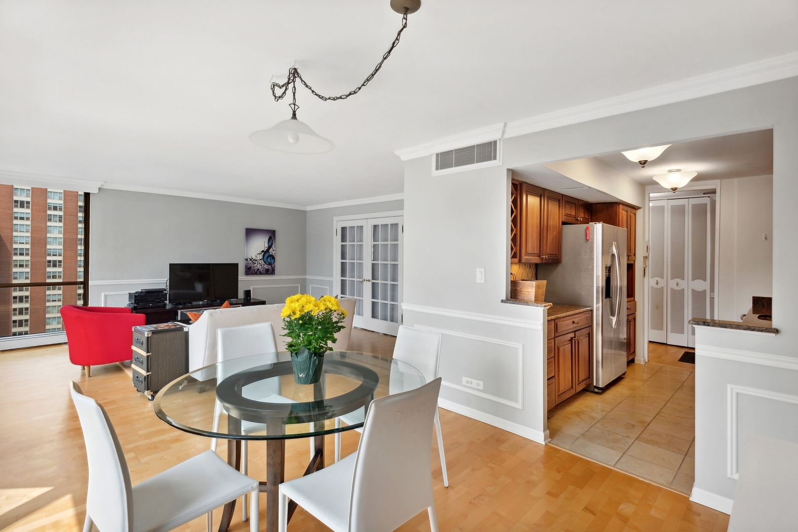 1310 North Ritchie Court, Unit 19B Chicago, IL 60610 - Photo 11 of 30 a view of a dining room with furniture and a chandelier