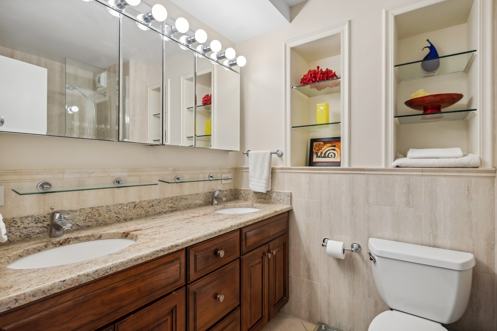 1310 North Ritchie Court, Unit 19B Chicago, IL 60610 - Photo 18 of 30 a bathroom with a granite countertop toilet sink and mirror