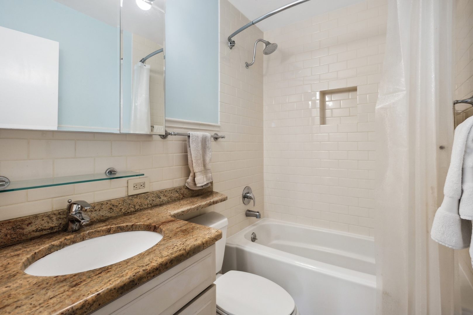 1310 North Ritchie Court, Unit 19B Chicago, IL 60610 - Photo 21 of 30 a bathroom with a granite countertop sink toilet a mirror and shower
