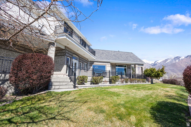 684 North Summit Way Alpine, UT 84004 - Photo 3 of 58 Rear view of house with brick siding, a lawn, and a mountain view