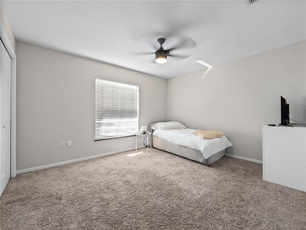 117 Rachel Lin Lane St. Cloud, FL 34771 - Photo 15 of 28 a spacious bedroom with a bed and a window