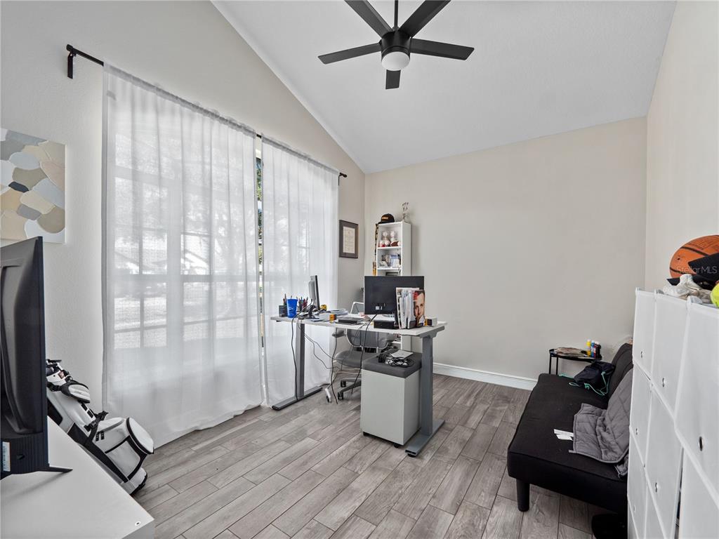 117 Rachel Lin Lane St. Cloud, FL 34771 - Photo 16 of 28 a living room with furniture a flat screen tv and a window