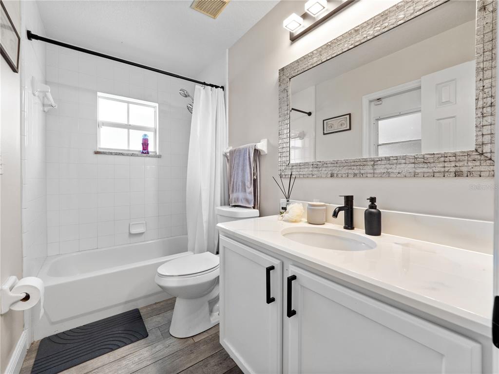 117 Rachel Lin Lane St. Cloud, FL 34771 - Photo 17 of 28 a bathroom with a sink a toilet and a large mirror