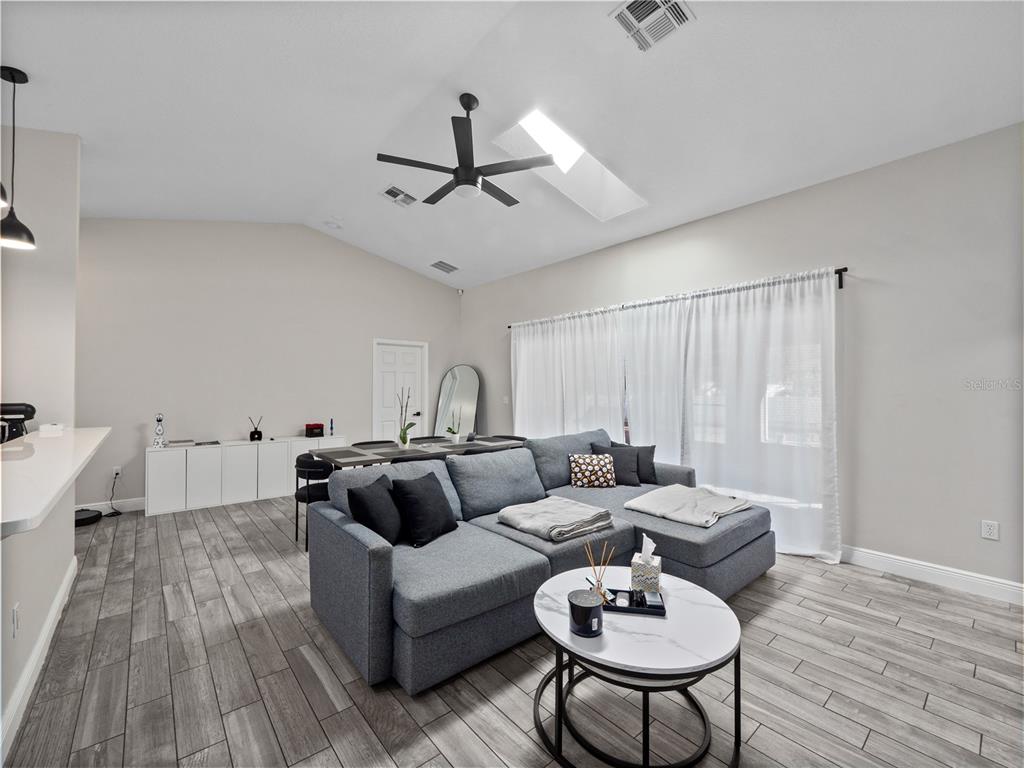 117 Rachel Lin Lane St. Cloud, FL 34771 - Photo 10 of 28 a living room with furniture and a wooden floor