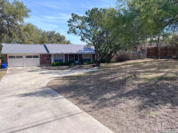 a tree in front of a house