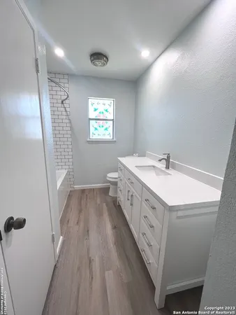 a bathroom with a sink a vanity and a large mirror
