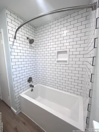 a bathroom with a bathtub and a shower