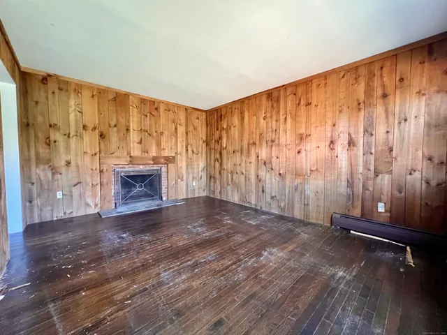 a view of room with stairs and wooden floor
