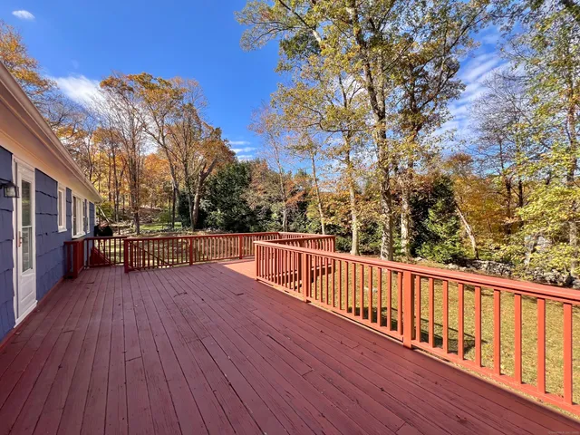 a view of a balcony with wooden floor and fence