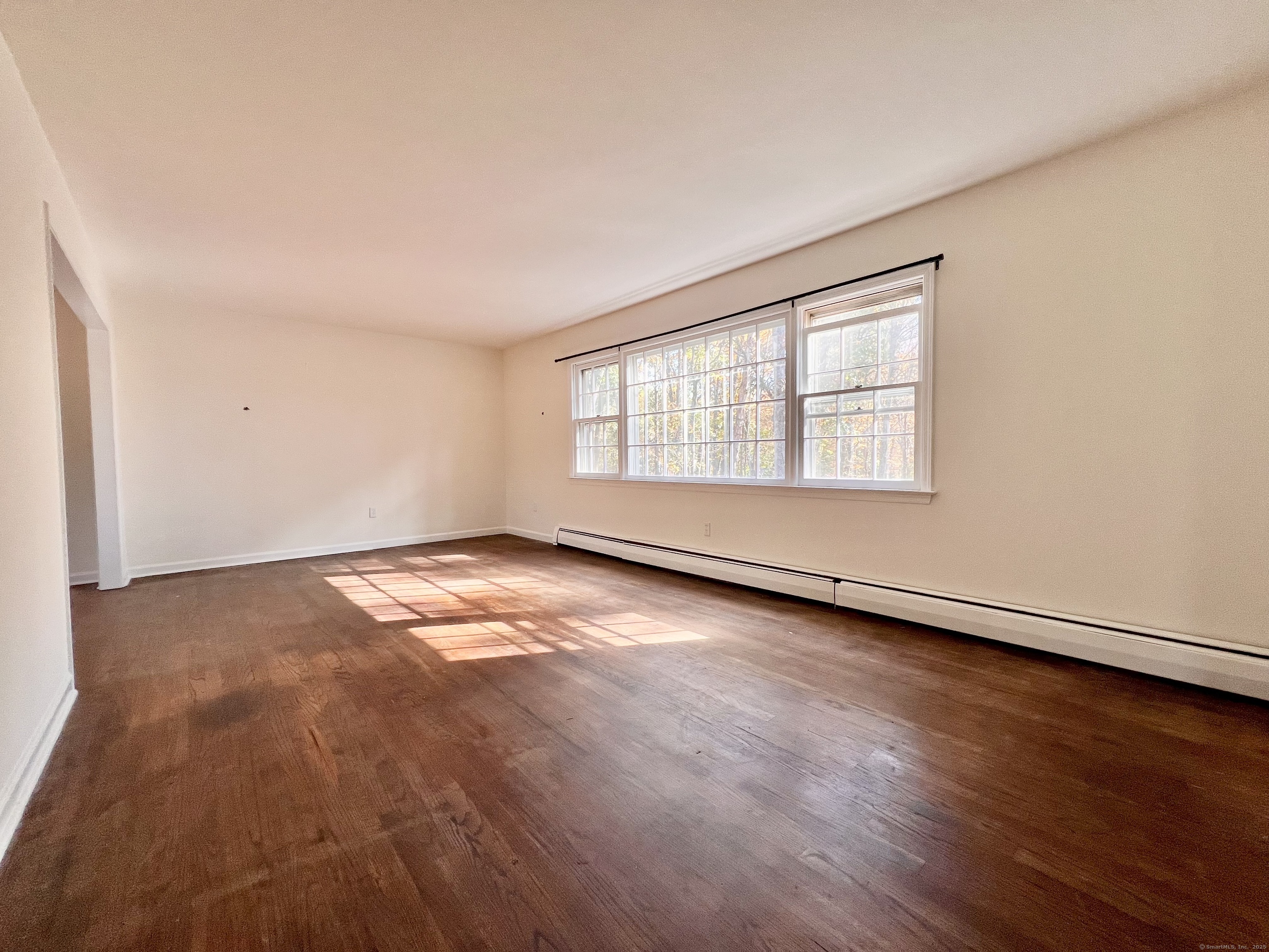 56 Partrick Road Westport, CT 06880 - Photo 6 of 21 an empty room with wooden floor and windows