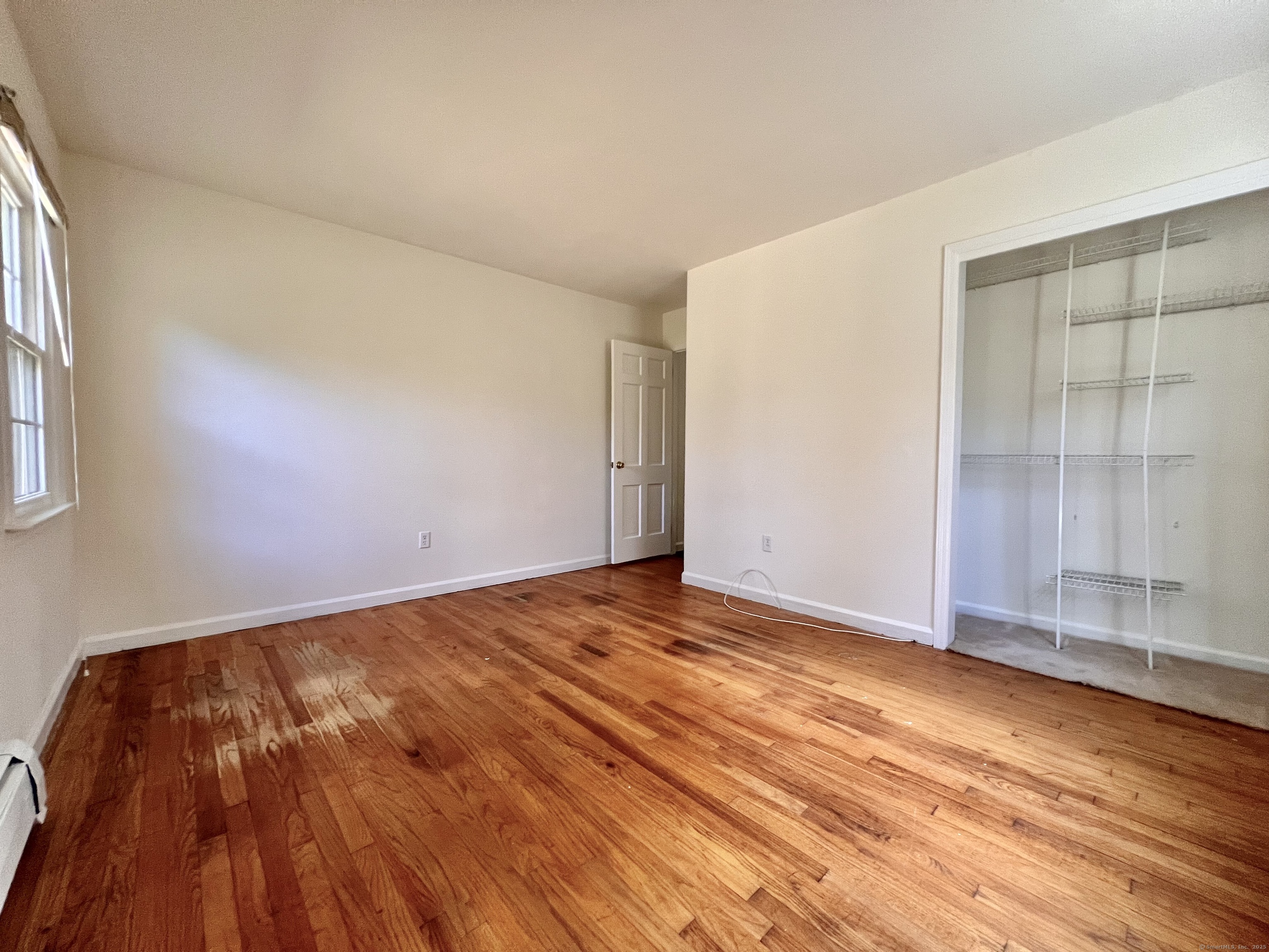 56 Partrick Road Westport, CT 06880 - Photo 8 of 21 an empty room with wooden floor and windows