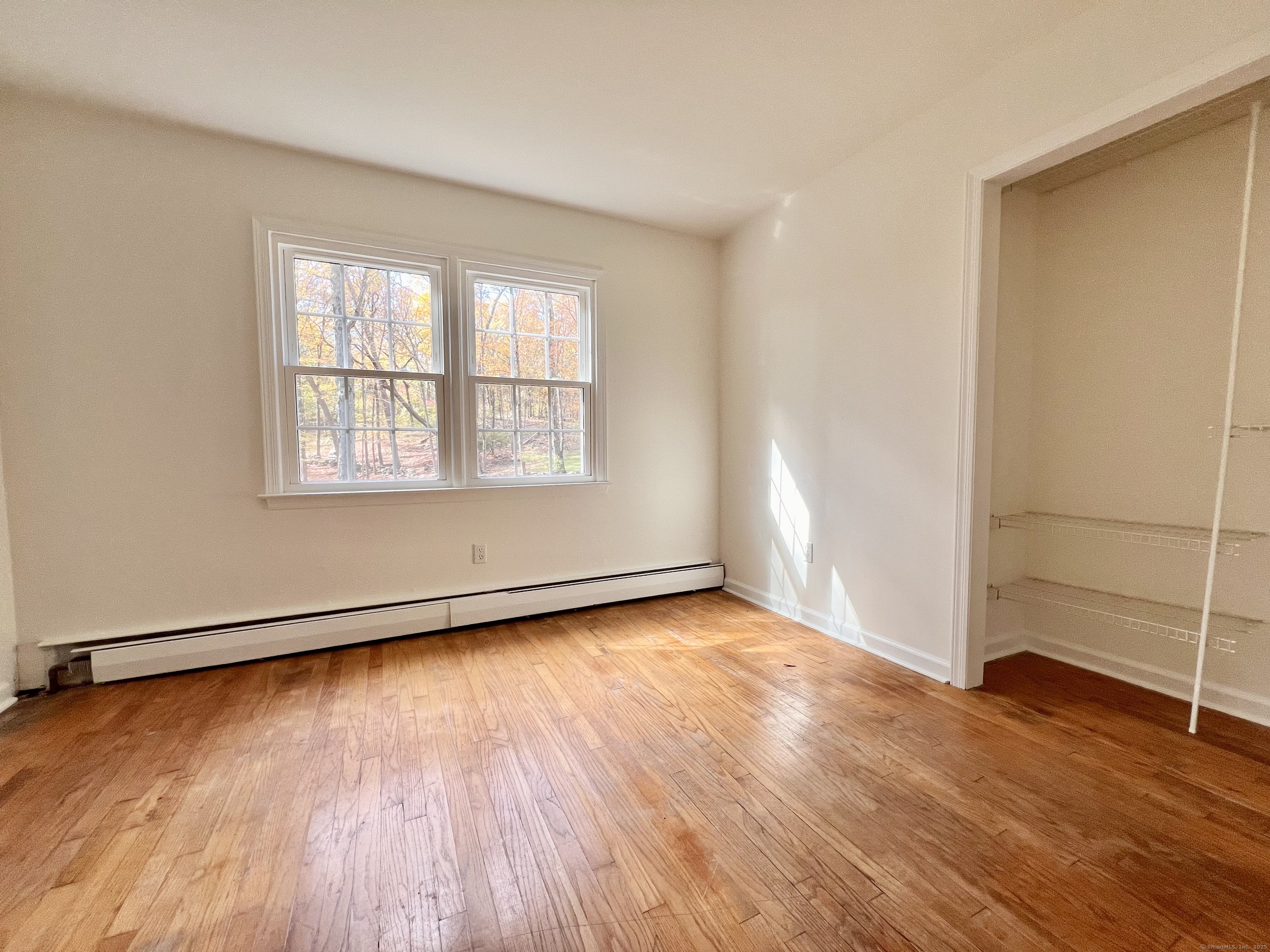 56 Partrick Road Westport, CT 06880 - Photo 10 of 21 an empty room with wooden floor and windows