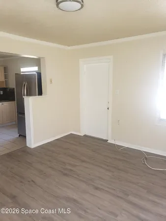 a kitchen with granite countertop white cabinets and stainless steel appliances
