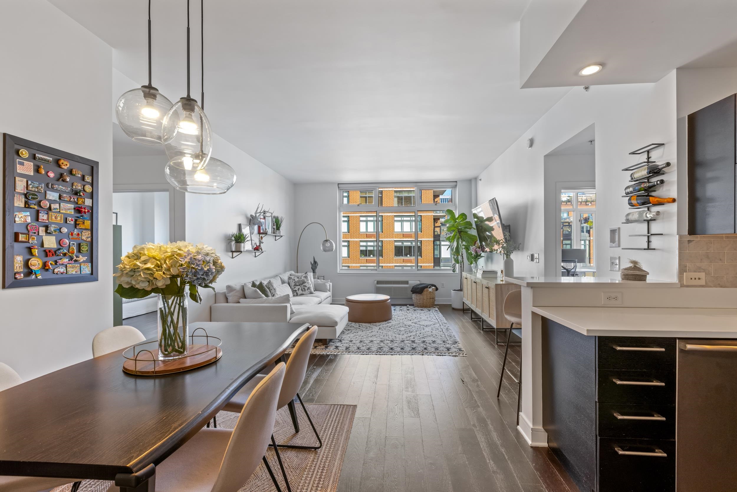 a kitchen with sink refrigerator dining table and chairs