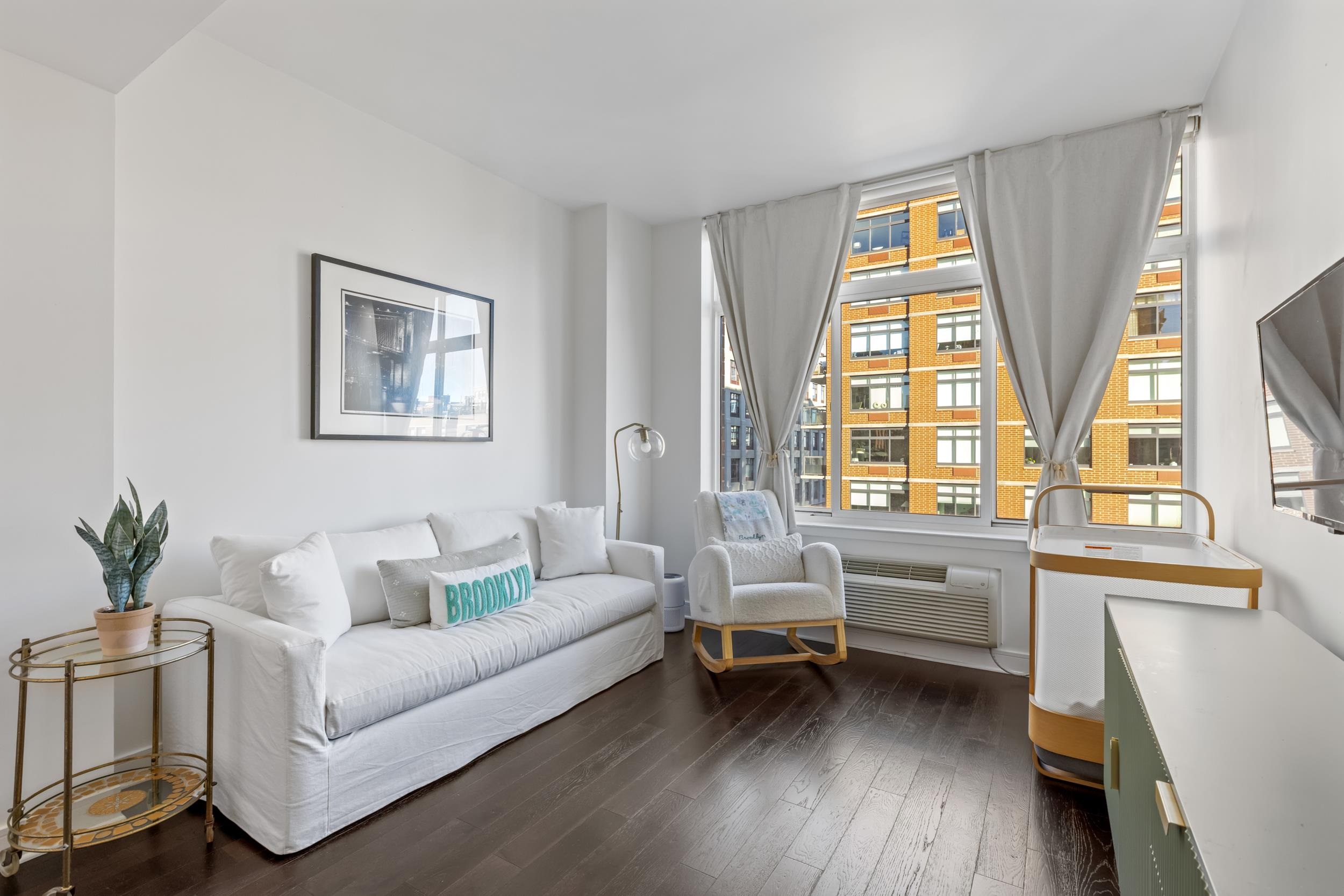 1450 Washington Street, Unit 608 Hoboken, NJ 07030 - Photo 12 of 44 a living room with furniture and a large window