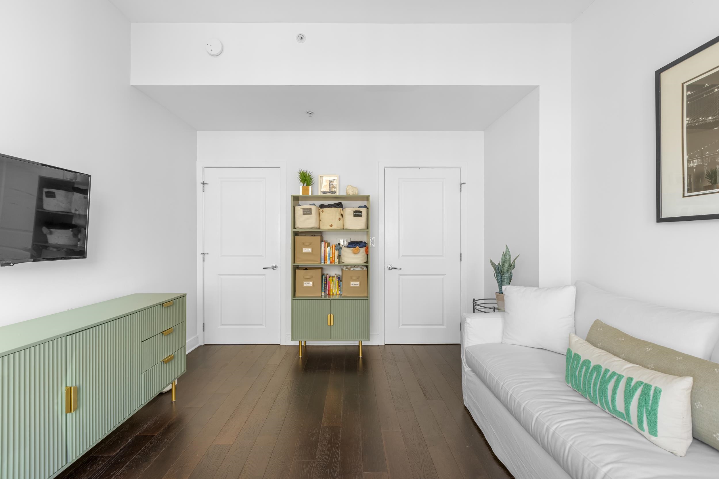 1450 Washington Street, Unit 608 Hoboken, NJ 07030 - Photo 13 of 44 a living room with furniture and a flat screen tv