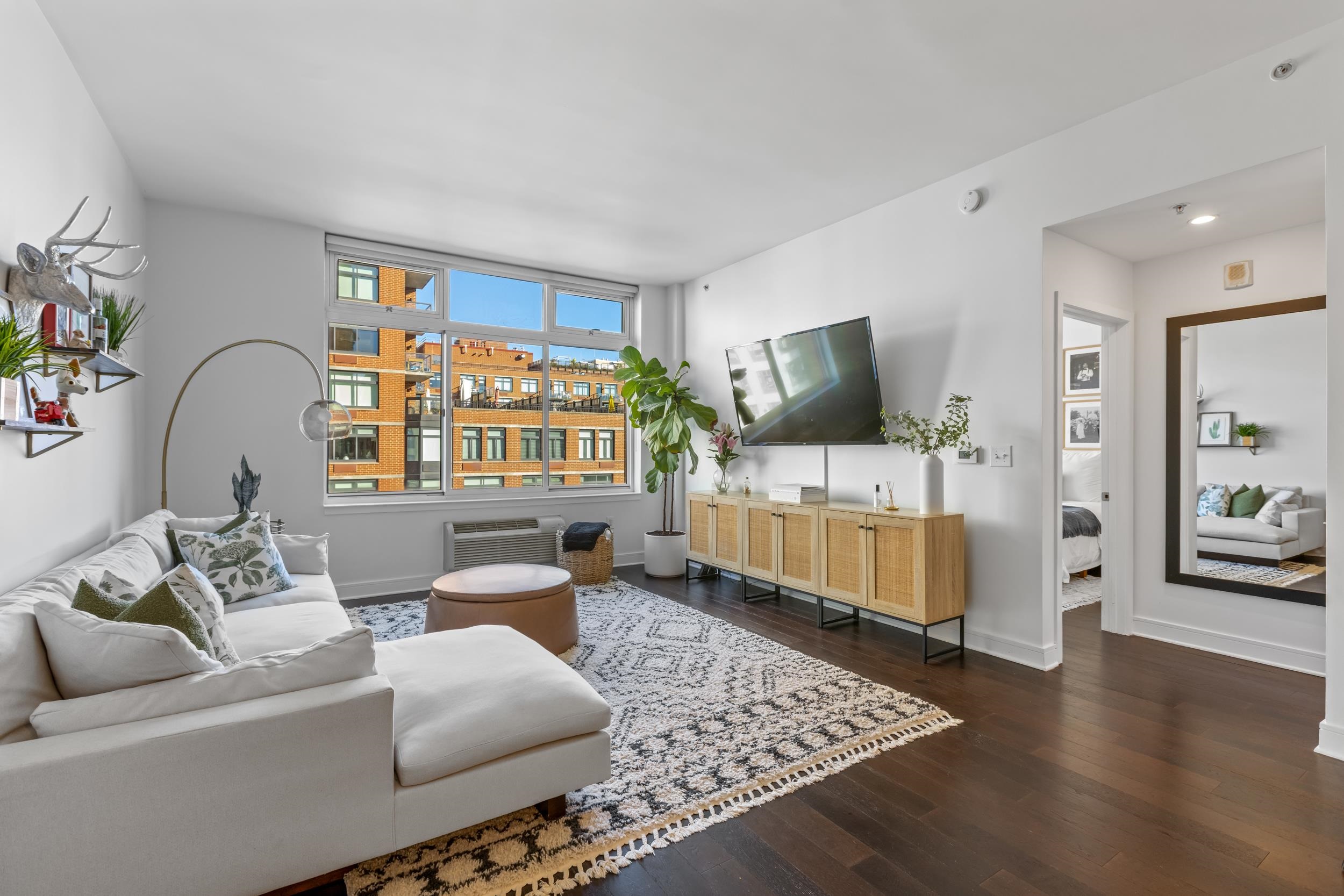 1450 Washington Street, Unit 608 Hoboken, NJ 07030 - Photo 2 of 44 a living room with furniture and a flat screen tv