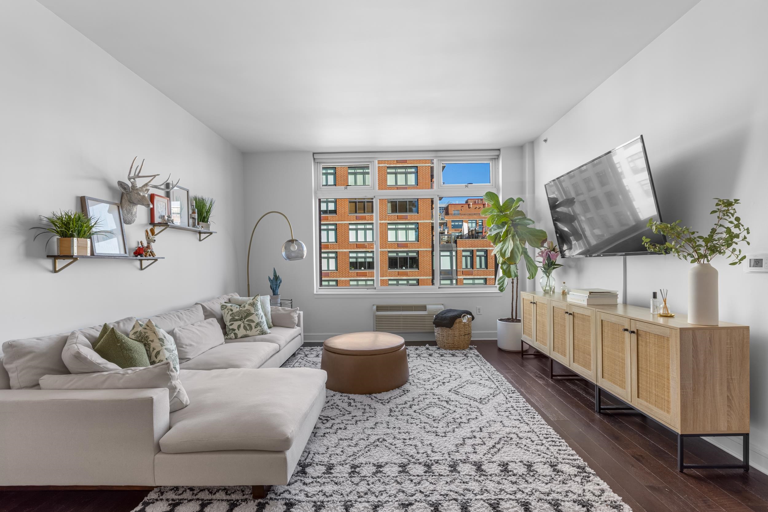 1450 Washington Street, Unit 608 Hoboken, NJ 07030 - Photo 3 of 44 a living room with furniture and a flat screen tv
