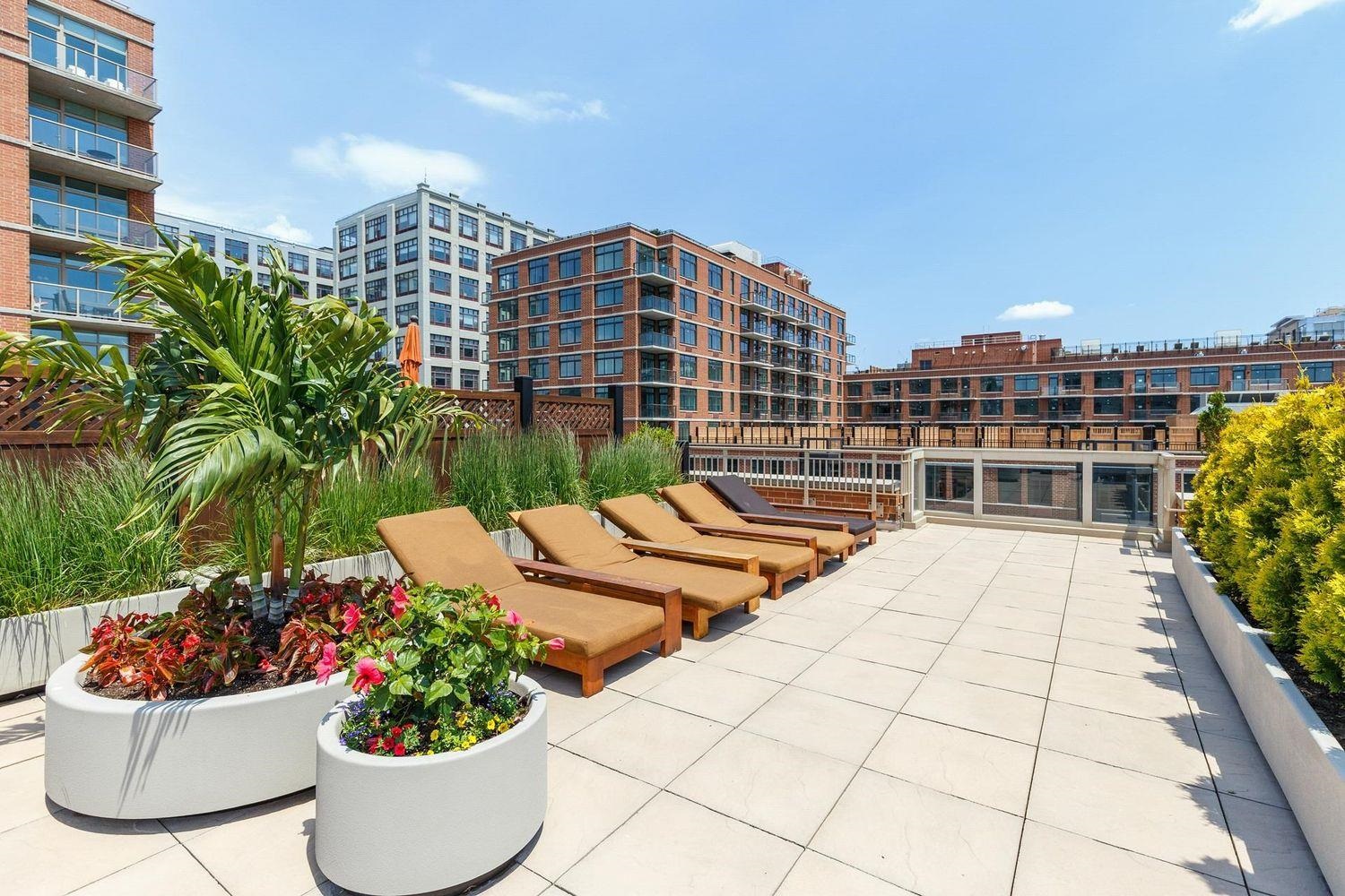1450 Washington Street, Unit 608 Hoboken, NJ 07030 - Photo 32 of 44 a view of a tall building and potted plants