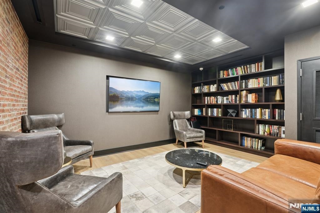 1450 Washington Street, Unit 608 Hoboken, NJ 07030 - Photo 36 of 44 a living room with furniture and a book shelf