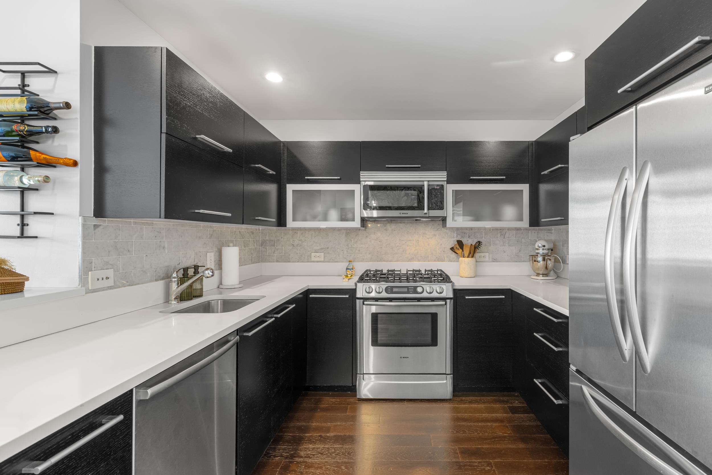 1450 Washington Street, Unit 608 Hoboken, NJ 07030 - Photo 4 of 44 a kitchen with stainless steel appliances granite countertop a sink stove and refrigerator