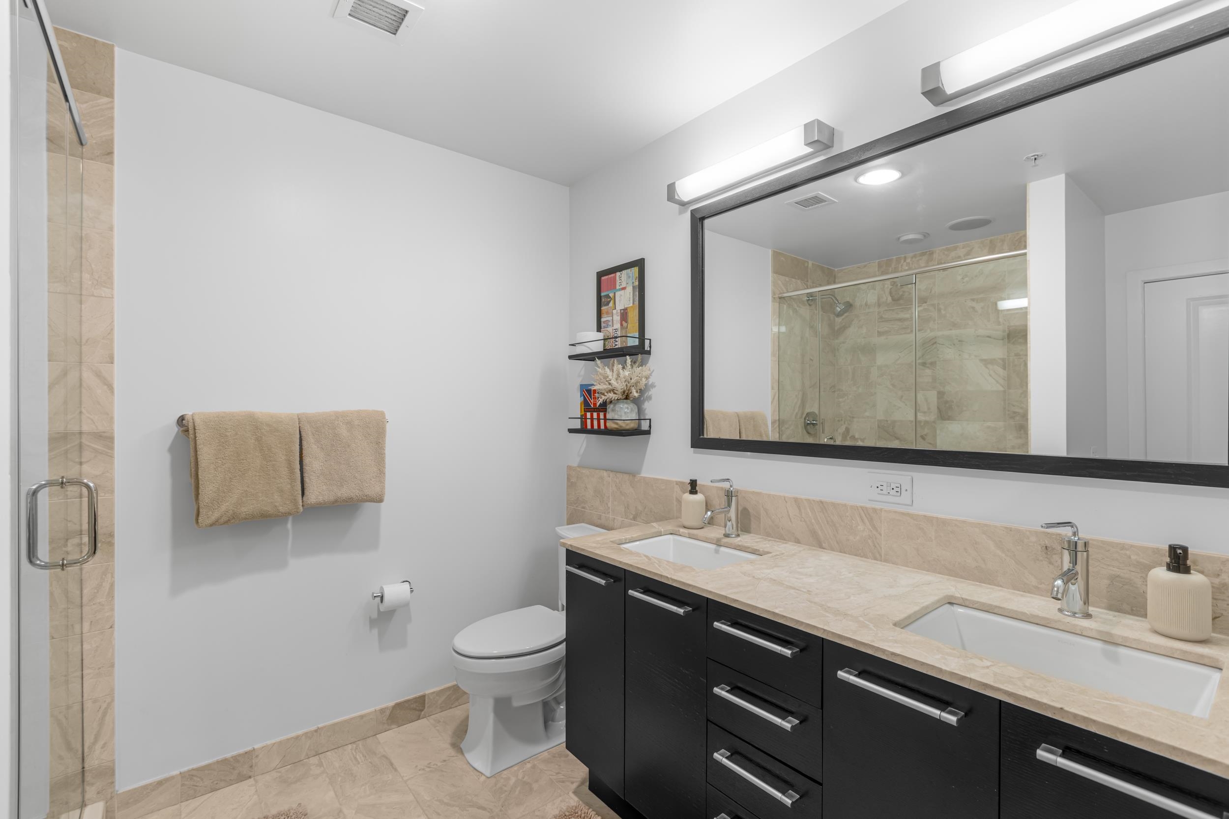1450 Washington Street, Unit 608 Hoboken, NJ 07030 - Photo 10 of 44 a bathroom with a granite countertop sink a toilet and a mirror