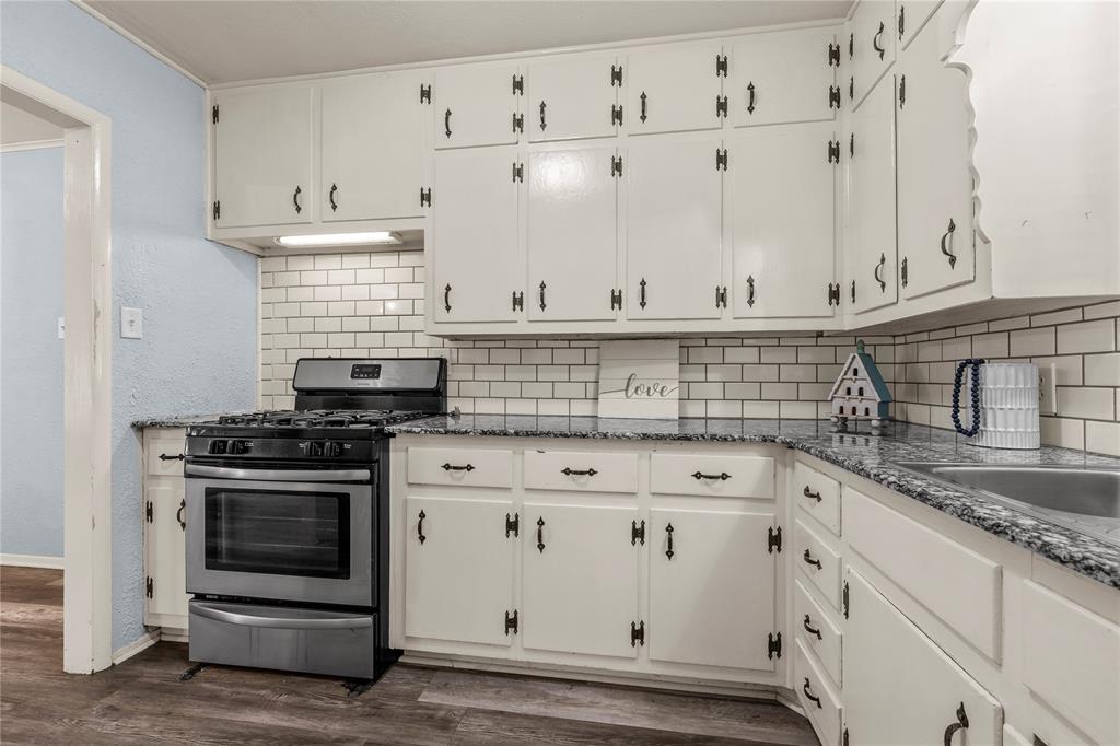 901 North Main Street West, TX 76691 - Photo 16 of 32 a kitchen with white cabinets and appliances